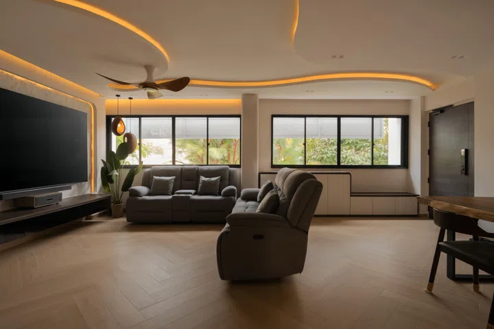 Flowing ceiling details, concealed lighting and a calm, earthy palette tie together the open-plan living, dining and entrance spaces into one cohesive whole.