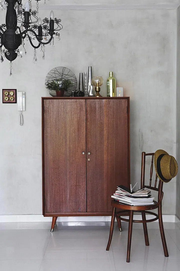 This mid-century wardrobe holds the interior designer Ong Jia Qi, founder of JQ Ong The Association's work materials in his 3-bedroom Executive Condominium (EC) in Pasir Ris.
