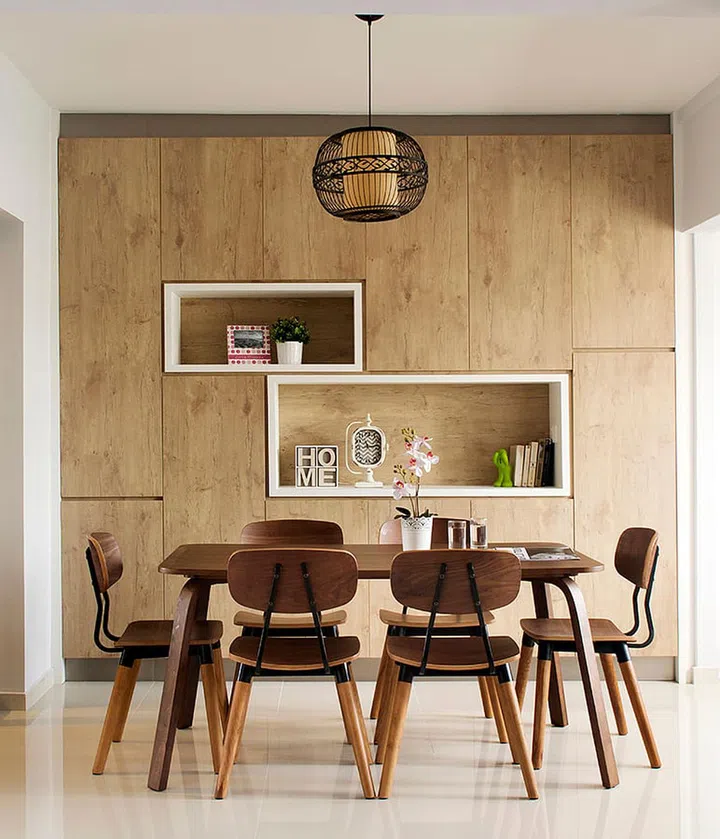 Scandinavian Industrial interior design with a wood carpentry feature wall with storage, and a dark walnut dining table and chair set in Tampines.