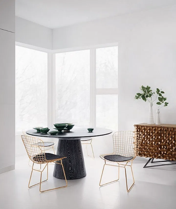 Dark wood round dining table with brass and leather chairs