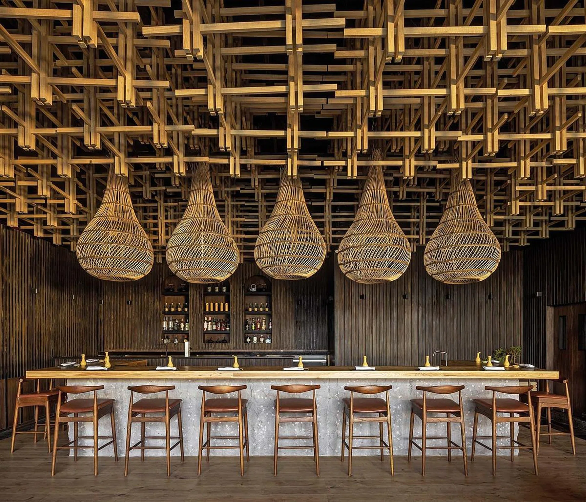 Nama Restaurant, Queretaro, Mexico City. Woven rattan shades contrast beautifully against the dark wood panelling. (RAFAEL GAMO)