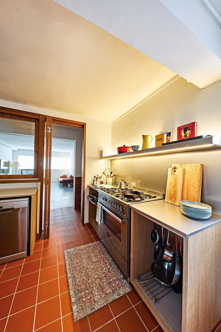 The walls and ceiling were painted white, making the kitchen and its terracotta tiles pop.