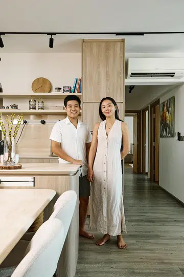 30s Couple lawyer Joshua and marketing director Li Yin poses for a photo in their newly-renovated 5-room resale HDB in Bukit Batok.