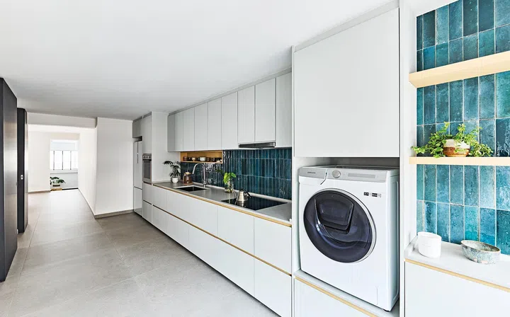 Having all the built-in cabinets, drawers and counter top on one side of the long and spacious kitchen keeps everything efficient and neat.