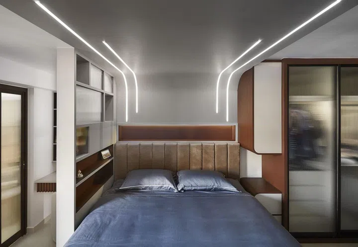Master bedroom with LED strip lights above the bed headboard in this 1,303 sq ft Tampines 5-room HDB.