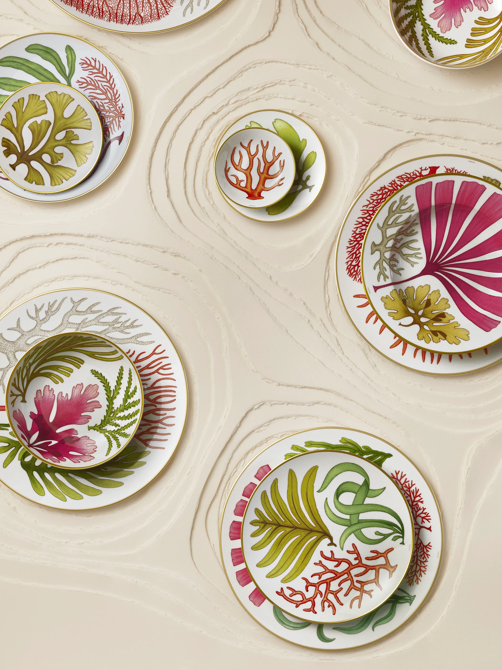 Hermès’ Natures Marines tableware collection launches in Singapore on 1 August 2026. Designed by British illustrator Katie Scott, the collection’s 34 pieces feature a marine garden inspired by nineteenth-century English botanical illustrations and the marine flora of the Welsh coastline.
