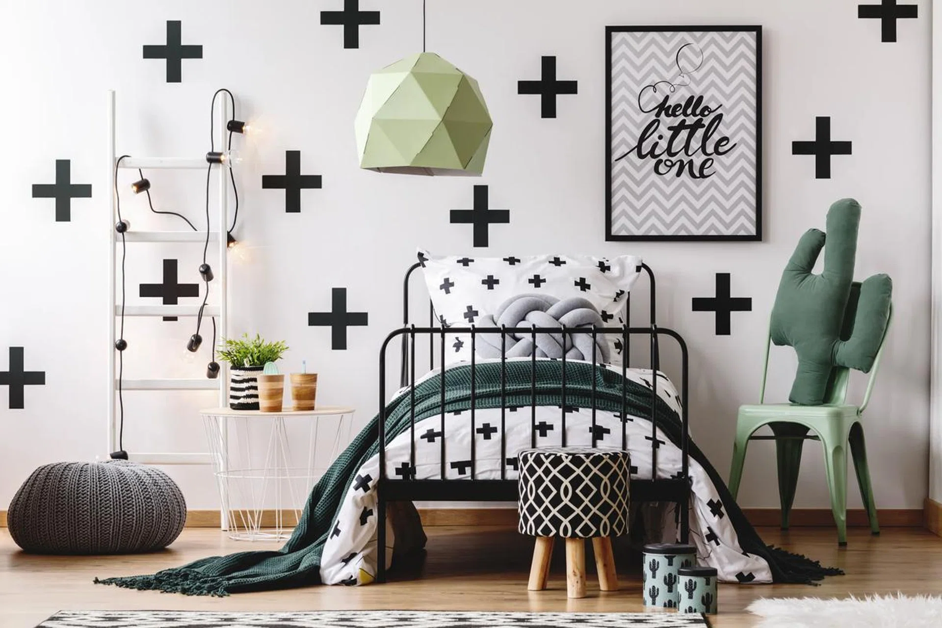 White ladder, grey pouf and cactus pillow on mint chair in kid's bedroom with green accents. Photo 123RF