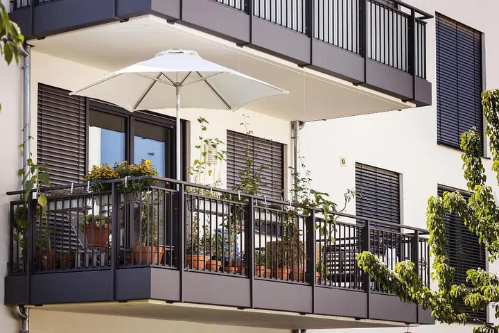 balcony-europe-modern-apartment-building-with-roller-blinds-flower-pots-modern-balcony-garden