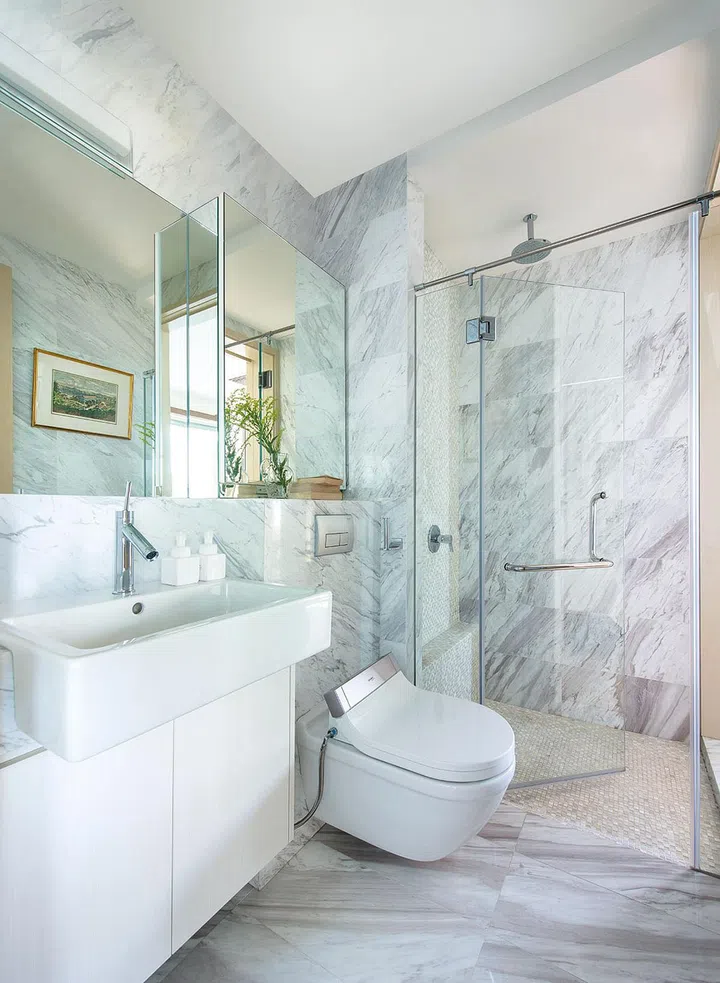 Cool marble in the guest bathroom exudes a sense of luxury and sophistication. Interior design by Collective Designs.