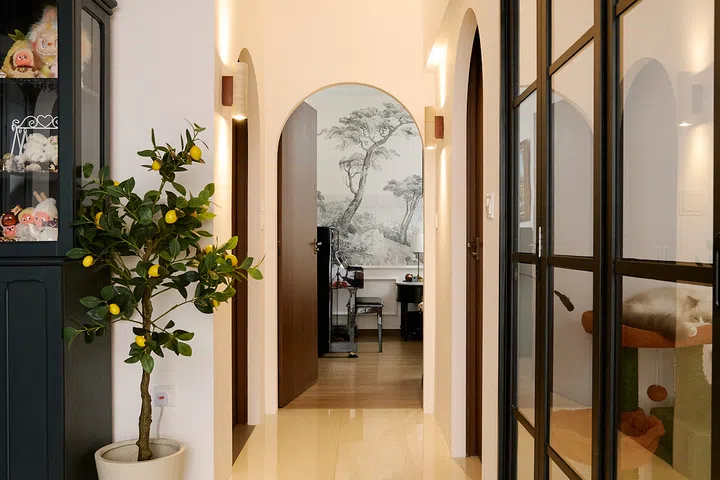 Arched facades disguise the original rectangular HDB door frames without replacing them.