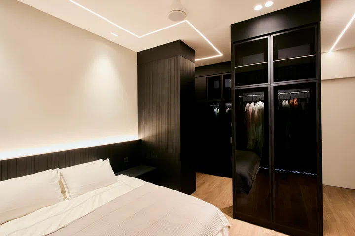 Wardrobes return to a dark, fully integrated treatment, blending seamlessly into the bedroom architecture.