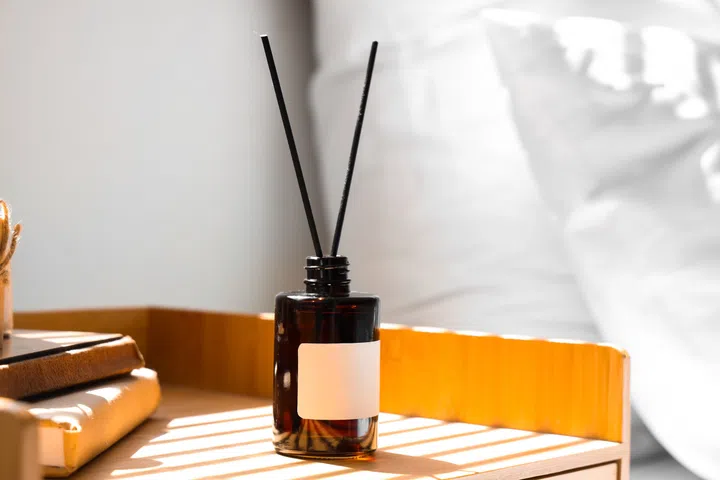 Bedside table with aroma diffuser  in bedroom, closeup
