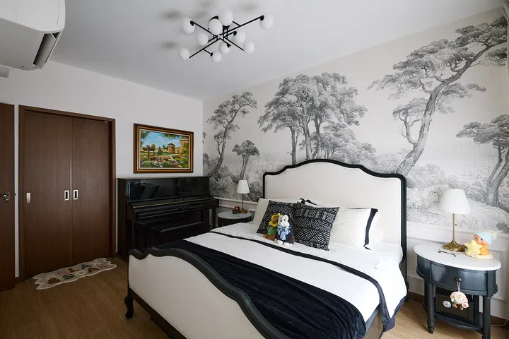 Monochrome furnishings let the scenic Saint-Tropez wallpaper take centre stage.