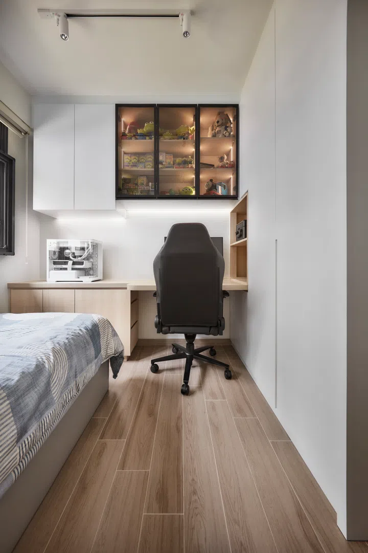 A simple study nook provides Ansel with a functional space for work and gaming, kept tidy with built-in carpentry.