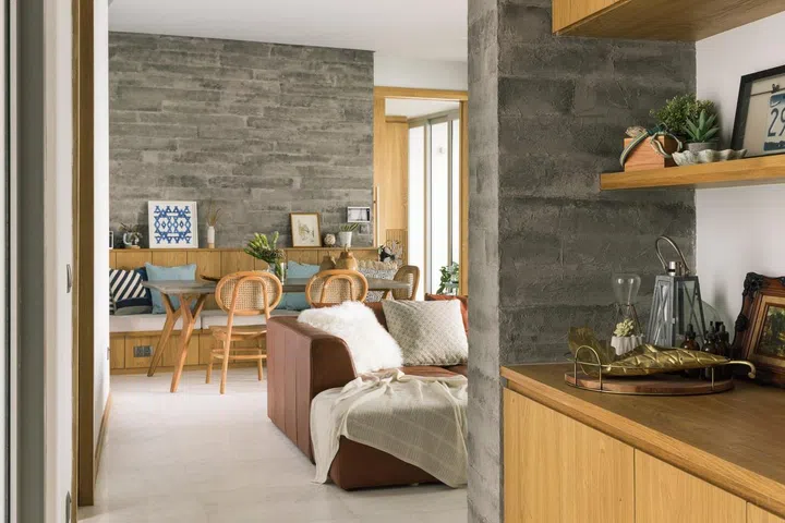 A  russet leather sofa softens the hard wooden edges found in the living room of this 1,900 sq ft 3-bedroom condominium in Sentosa.