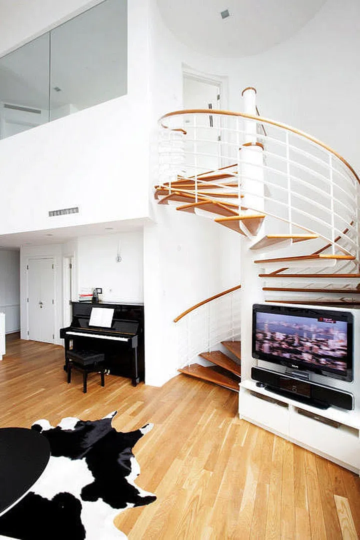 The family piano fits perfectly in the otherwise unused space, under the stairs. Design by Frame Interior