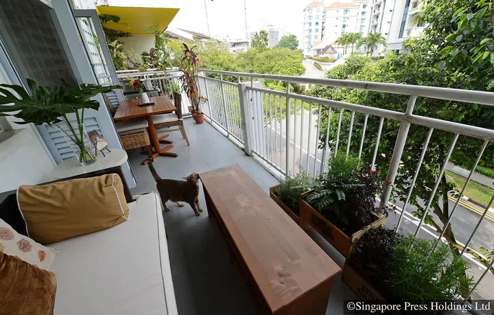 A couch and dining set at a balcony of local actress-host Cynthia Lee MacQuarrie's rented 1,400 sq ft walk-up apartment in Chip Bee Gardens.