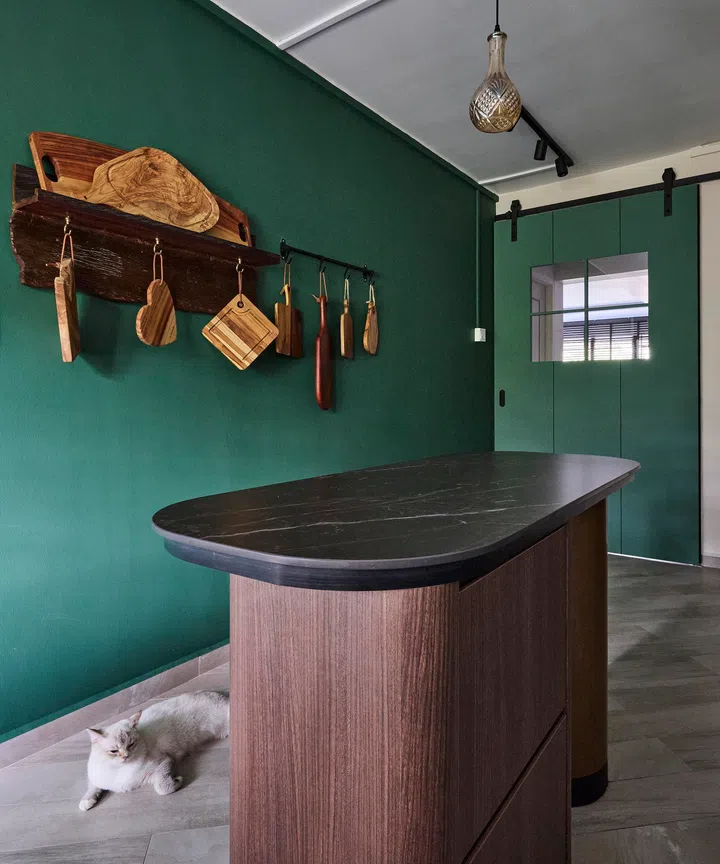 Her kitchen island and treasured cheeseboard wall in a 4-room HDB resale in Sunset Way.