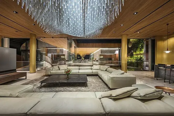 Living room with large sofas and a grand chandelier