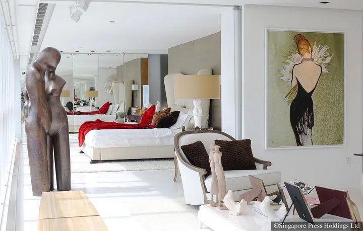 The high-back Fortuny bed, which looks out to the panoramic Marina Bay area, in the master bedroom in British luxury furniture designer Christopher Guy Harrison's three-bedroom apartment in High Street Centre.