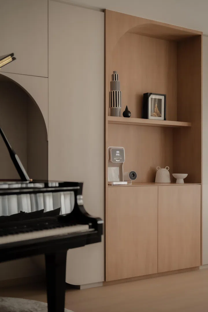 A full-height storage and pantry wall with softened corners aligns with the ceiling curves above, integrating dry pantry functions seamlessly into the living space.