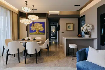 An open layout links the dining, kitchen island, and living spaces, creating flow and connectivity.