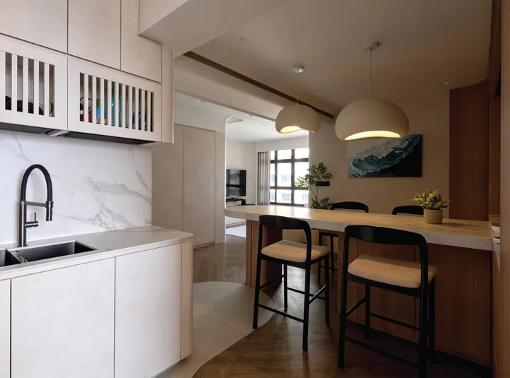 The entrance to the kitchen is tucked neatly beside the dining area, blending style with accessibility.