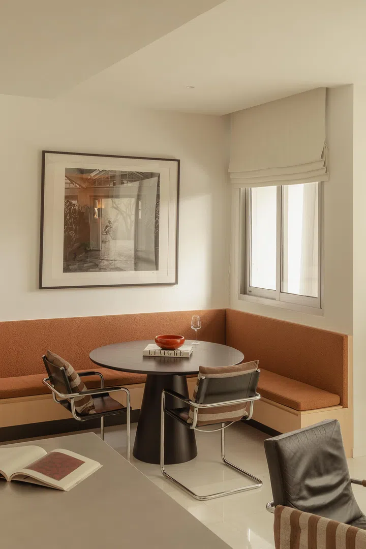 The custom banquette creates a room-within-a-room effect—a versatile nook for meals, work, or quiet family time.