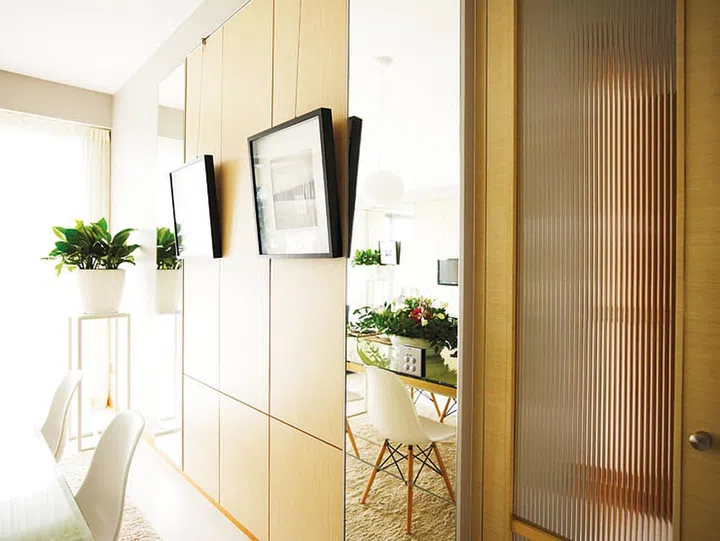 Framed artwork hanging on the dining room walls of a 4-bedroom apartment in Oceanfront @ Sentosa Cove condominium with luxurious interior design.