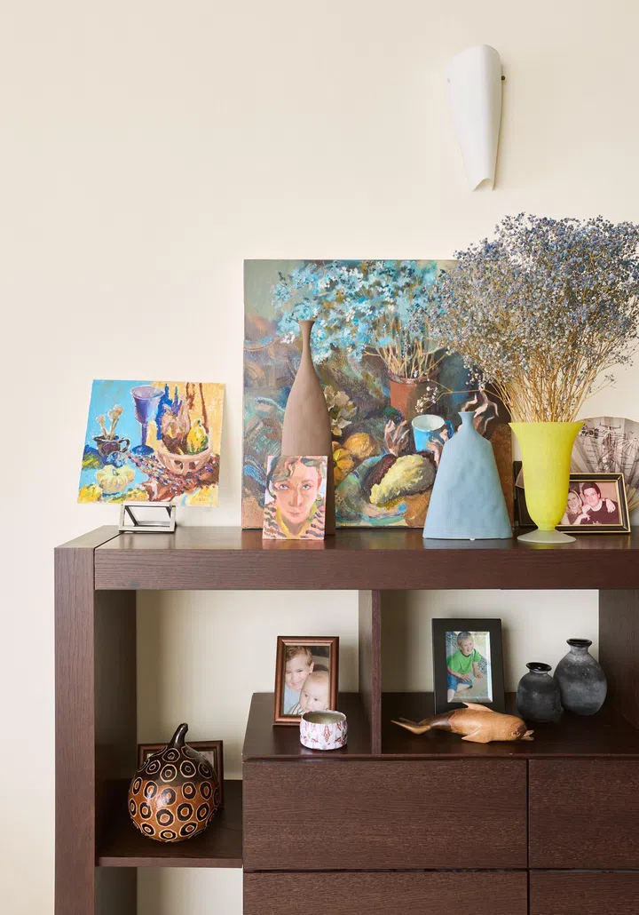 A simple wooden shelf displaying decorative vases, reflecting a blend of contemporary and Asian-inspired design.

