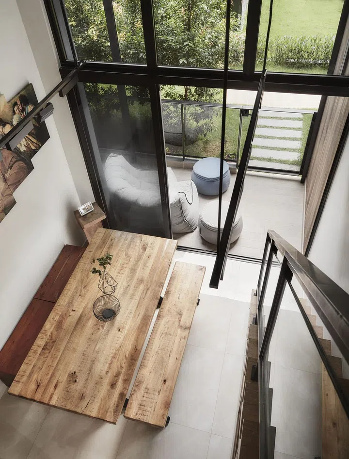 wooden dining table and balcony view from loft