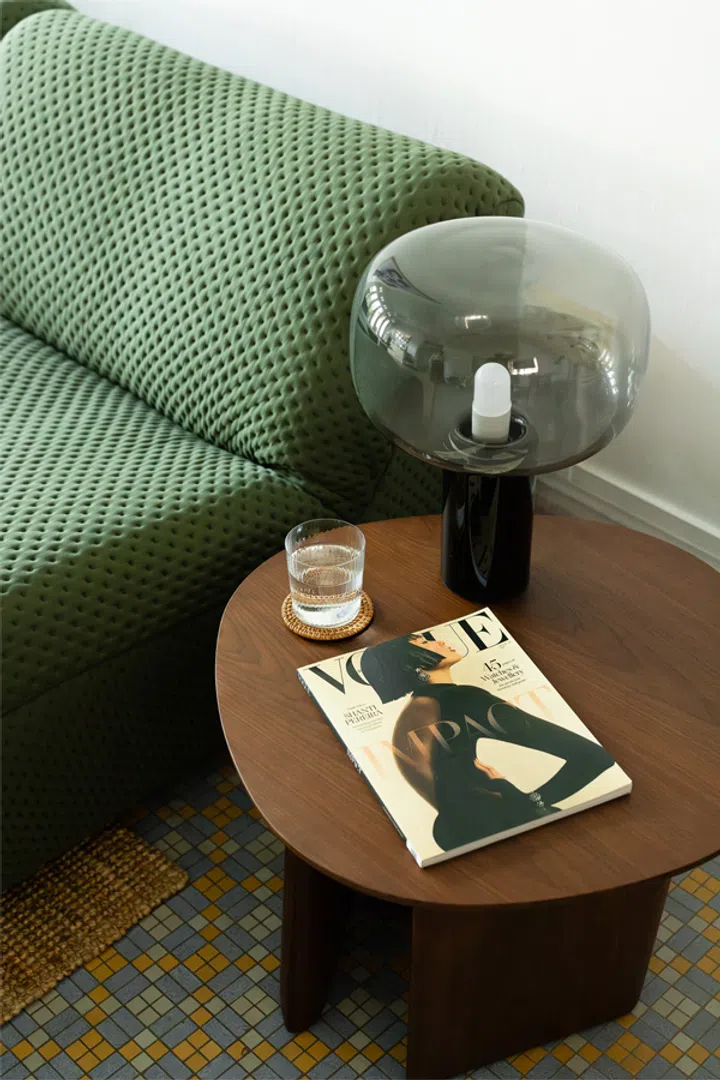 King Living Pallino table lamp with glass sphere sitting on brown Issho side table next to the 1977 sofa 