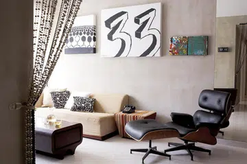 The “33” painting is the homeowner's note to himself, to be financially stable by that age. The Eames lounger was a present to himself. Interior designer Ong Jia Qi, founder of JQ Ong The Association's 3-bedroom Executive Condominium (EC) in Pasir Ris.