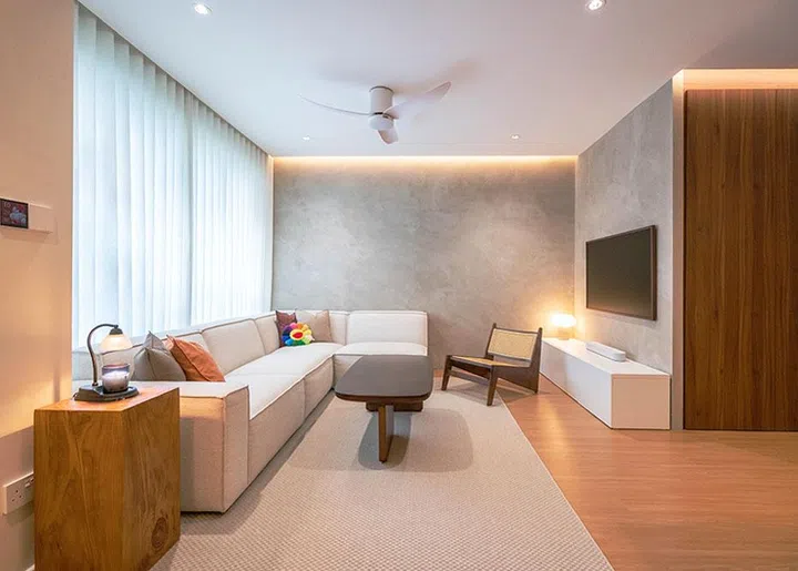 The reconfigured living area, where the sofa and TV placement maximize lounging and hosting space in a compact HDB layout.