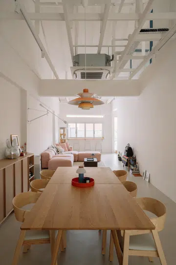 The home's open-plan living and dining spaces are framed by exposed roof trusses and bespoke oak cabinetry, complemented by carefully curated furniture and lighting from some of the couple's favourite Nordic brands.