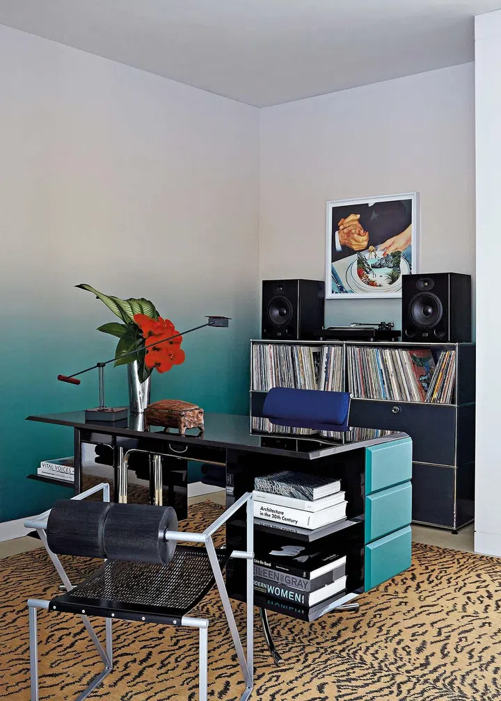 Calico wallpaper; Poul Henningsen desk; Eames (upholstered) and Mario Botta chairs; Stilnovo vintage lamp by Shigeaki Asahara; USM storage unit; Mitchell Denburg carpet.