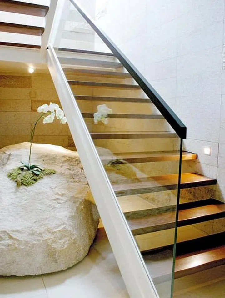 Natural materials like wood, stone as well as granite enhance the home’s green environment. In the basement, a rock sculpture guards the end of the stairwell.