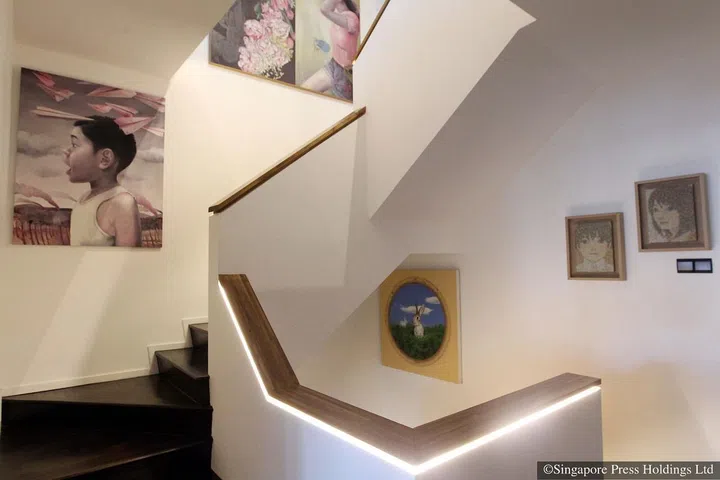 A painting by Malaysian artist Janiz Chan, titled World War II, of a boy fascinated by paper planes, hangs in the stairwell of adman Jeff Cheong's three-storey house in Telok Kurau Road.