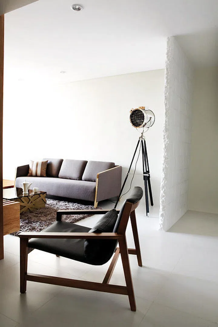 The rough-hewn edges of the brick wall and unfinished look of the coffee table lend texture to a room that would otherwise have looked too polished. Teapot and cup from Egg3 Playfair. 