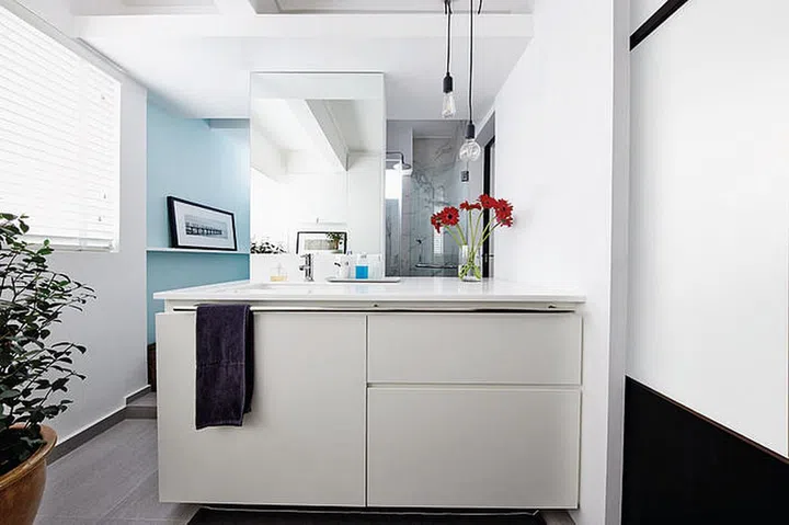 There are two entrances to the bathroom-cum-laundry room: from the kitchen (not seen) on the right and from the study (with the blue wall).