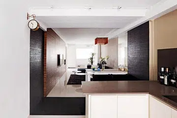 The white walls are complemented by warm tones, such as the wood-like walls and tassel ceiling lamp.