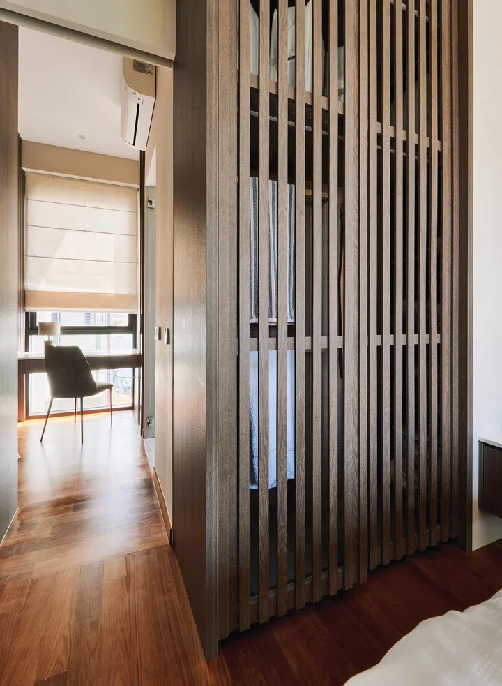 Slatted wardrobe doors provide ventilation while cleverly concealing “half-clean clothes” and daily essentials.