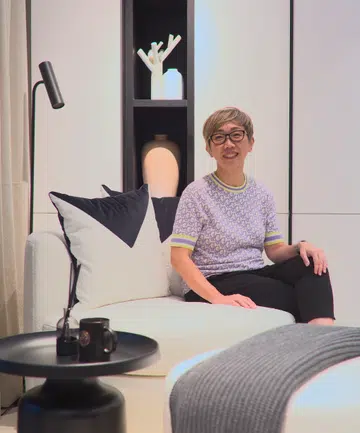 Bachelorette, Julie Lim, poses for a photo in her 1-bedroom condo along Farrer Road.