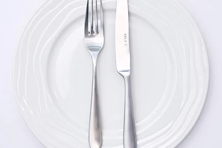 Utensils place parallel, facing away from you signal to waiters that you're done with your dish.