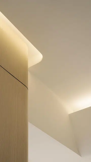 Curved cove lighting runs throughout this 4-room HDB in Punggol.