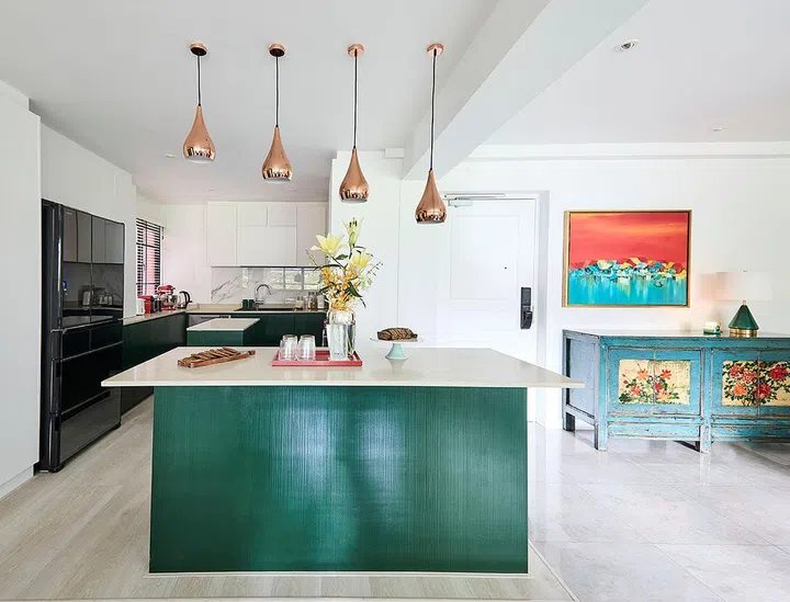 The dining area features monochromatic accents and a touch of gold.