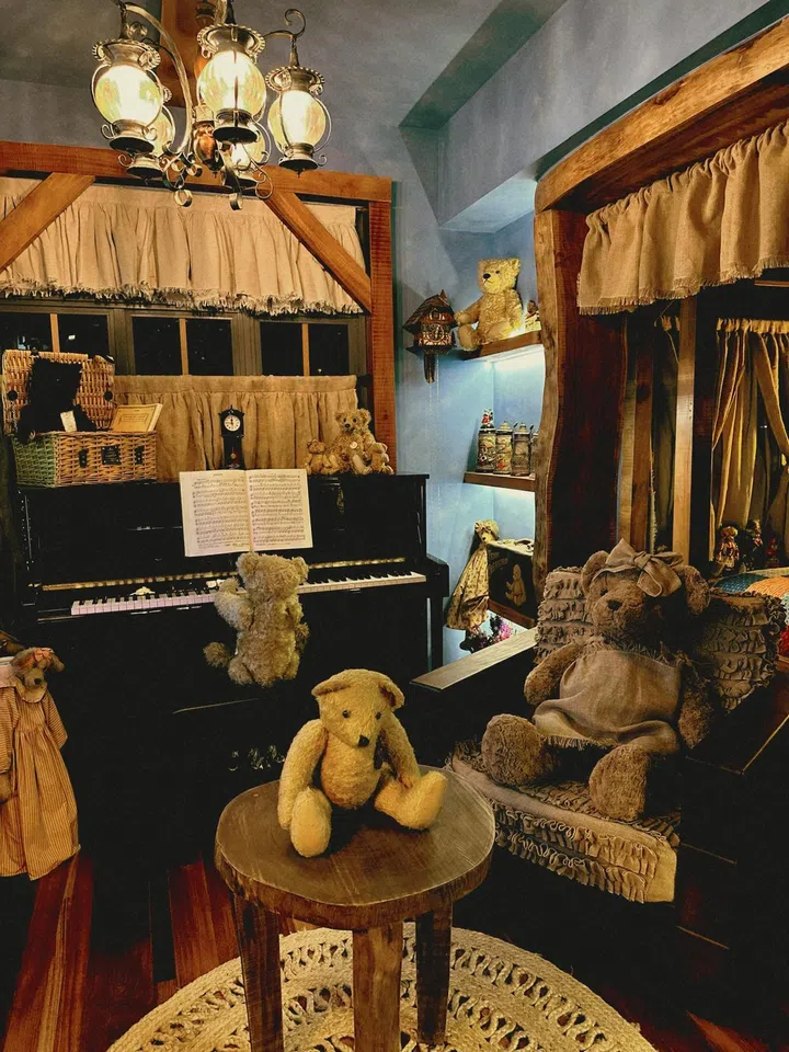 The prized Titanic Bear sits above the piano, along with the other bears. 