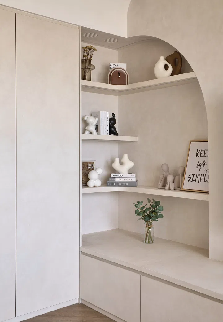 The entrance foyer features a curved wall detail that softens the look of integrated storage.