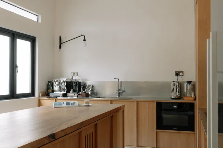 The oversized oak island was designed primarily as a generous workspace for Lena’s sourdough baking, a passion she picked up in Copenhagen.