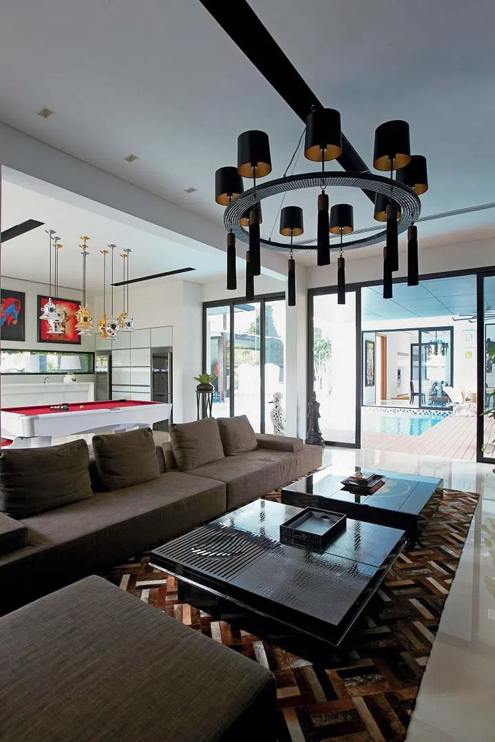The sitting area is furnished for comfort with its long sofa, large cowhide rug and tasselled ceiling lamp. 
